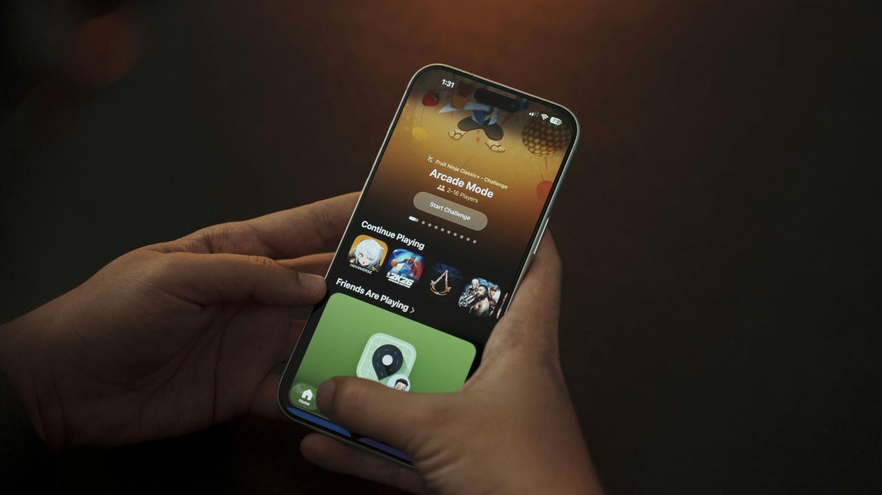 Person holding a smartphone with apps displayed