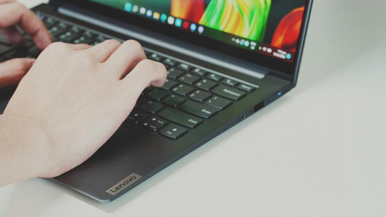Person typing on a laptop keyboard